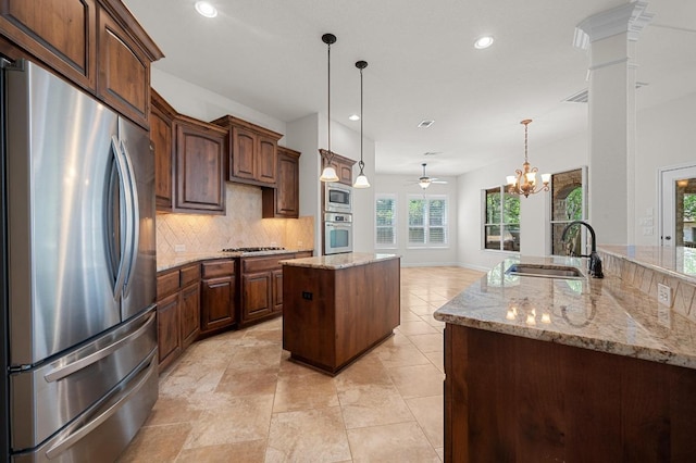 12304 Buvana Dr, Austin, TX 78739 - kitchen with appliances with stainless steel finishes, a sink, a center island, backsplash, and recessed lighting
