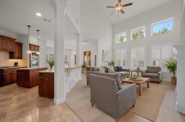 12304 Buvana Dr, Austin, TX 78739 - living room featuring decorative columns, ceiling fan, and a high ceiling