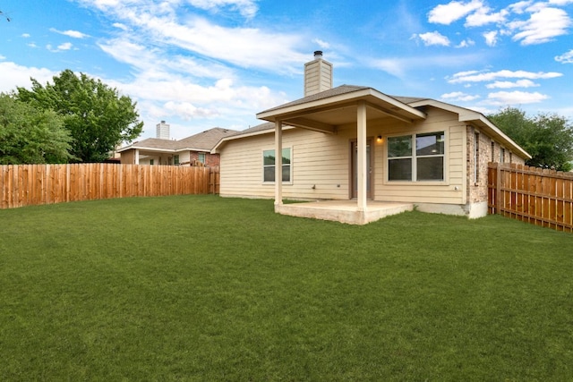 117 N Maplewood, Kyle, TX 78640 - back of house featuring a chimney, a fenced backyard, and a patio area