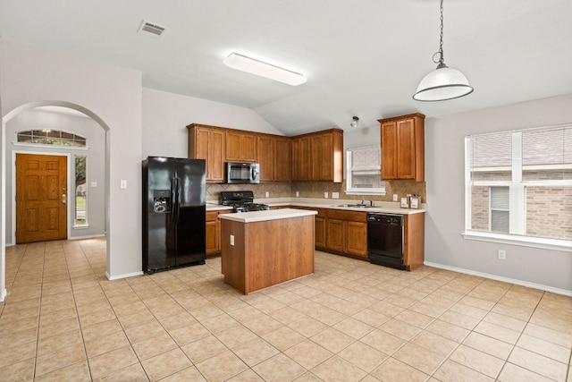 117 N Maplewood, Kyle, TX 78640 - kitchen with black appliances, light countertops, plenty of natural light, vaulted ceiling, and tasteful backsplash