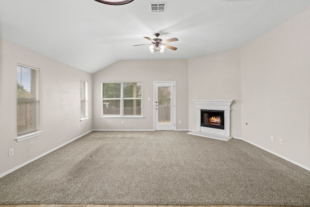 117 N Maplewood, Kyle, TX 78640 - unfurnished living room featuring a ceiling fan, a lit fireplace, carpet flooring, and lofted ceiling
