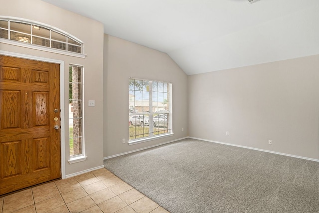 117 N Maplewood, Kyle, TX 78640 - foyer entrance featuring light carpet, vaulted ceiling, and light tile patterned floors