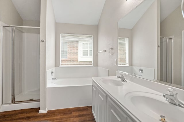 117 N Maplewood, Kyle, TX 78640 - bathroom with a stall shower, a bath, wood finished floors, and double vanity