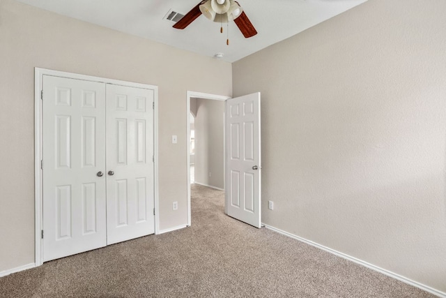 117 N Maplewood, Kyle, TX 78640 - unfurnished bedroom featuring carpet, a closet, and a ceiling fan