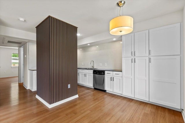 2200 Dickson Dr Unit 117, Austin, TX 78704 - kitchen featuring dishwasher, light wood-style floors, a sink, white cabinets, and dark countertops