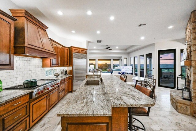 921 Electra, Lakeway, TX 78734 - kitchen with stainless steel appliances, a breakfast bar, a sink, tasteful backsplash, and recessed lighting