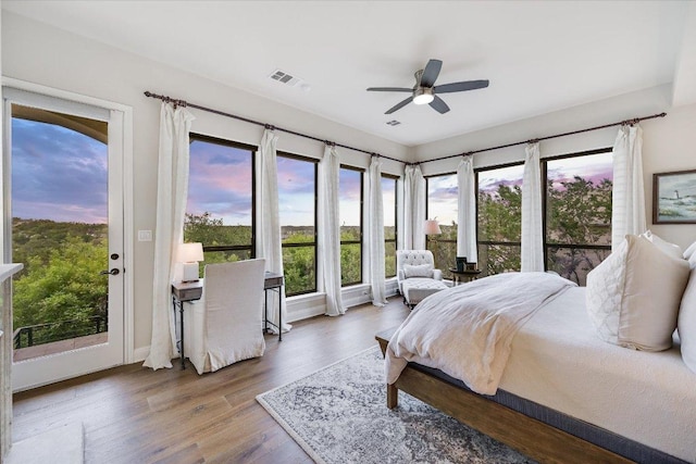 921 Electra, Lakeway, TX 78734 - bedroom featuring multiple windows, wood finished floors, access to exterior, and ceiling fan