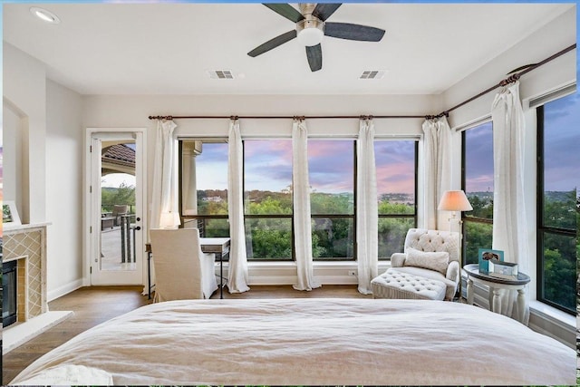 921 Electra, Lakeway, TX 78734 - bedroom featuring wood finished floors, a glass covered fireplace, baseboards, recessed lighting, and ceiling fan