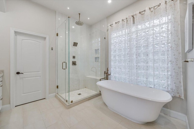921 Electra, Lakeway, TX 78734 - full bath featuring a shower stall, a freestanding tub, baseboards, tile patterned flooring, and recessed lighting