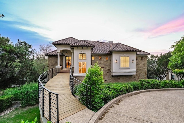921 Electra, Lakeway, TX 78734 - mediterranean / spanish-style home featuring stone siding, a tile roof, and stucco siding
