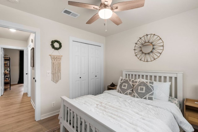 215 Crystal Knoll Blvd, Georgetown, TX 78626 - bedroom with light wood-style floors, a closet, baseboards, and a ceiling fan
