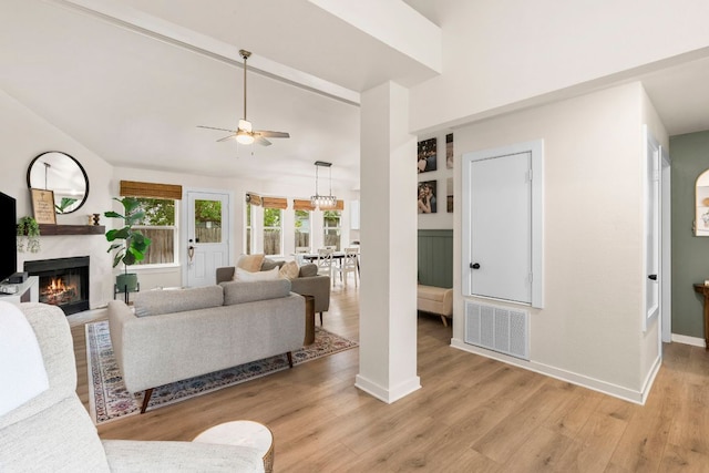 215 Crystal Knoll Blvd, Georgetown, TX 78626 - living room with a ceiling fan, a high end fireplace, lofted ceiling, baseboards, and light wood-style flooring
