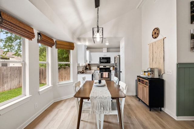 215 Crystal Knoll Blvd, Georgetown, TX 78626 - dining space with healthy amount of natural light, light wood-type flooring, baseboards, and high vaulted ceiling