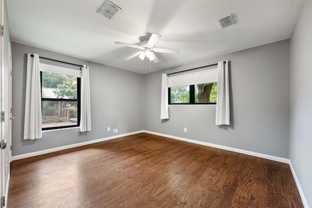 1506 Northridge Dr, Austin, TX 78723 - empty room featuring healthy amount of natural light, baseboards, dark wood finished floors, and a ceiling fan