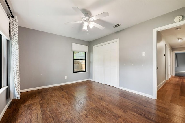 1506 Northridge Dr, Austin, TX 78723 - unfurnished bedroom with wood finished floors, a closet, baseboards, and a ceiling fan