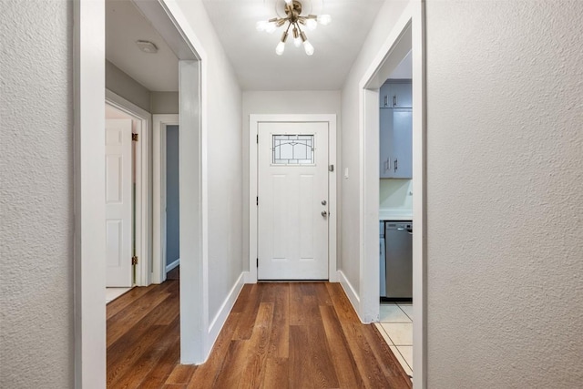 1506 Northridge Dr, Austin, TX 78723 - entrance foyer with a chandelier, wood finished floors, baseboards, and a textured wall