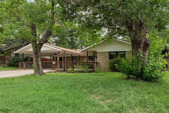 1506 Northridge Dr, Austin, TX 78723 - view of front facade featuring driveway, brick siding, a front yard, and covered porch