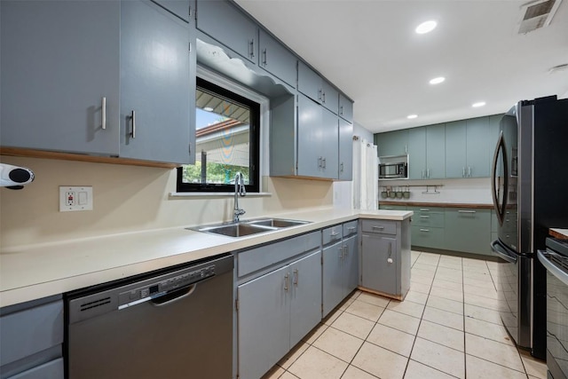 1506 Northridge Dr, Austin, TX 78723 - kitchen featuring appliances with stainless steel finishes, a sink, recessed lighting, light countertops, and light tile patterned floors