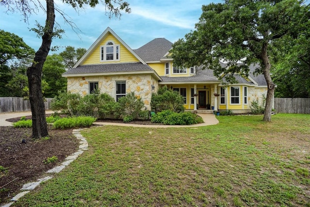 233 Maple Leaf Trl, Elgin, TX 78621 - traditional-style house with stone siding, roof with shingles, and covered porch