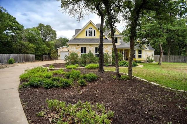 233 Maple Leaf Trl, Elgin, TX 78621 - view of front facade featuring stone siding, concrete driveway, a shingled roof, and a garage