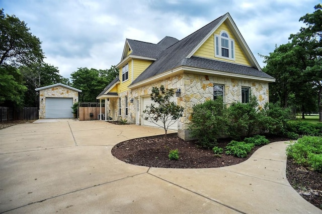 233 Maple Leaf Trl, Elgin, TX 78621 - view of property exterior featuring stone siding, a shingled roof, and driveway