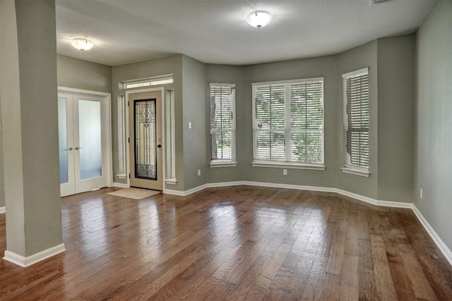 233 Maple Leaf Trl, Elgin, TX 78621 - foyer entrance featuring wood finished floors, french doors, and baseboards