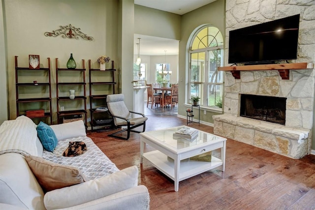 233 Maple Leaf Trl, Elgin, TX 78621 - living room featuring wood finished floors, a fireplace, and baseboards
