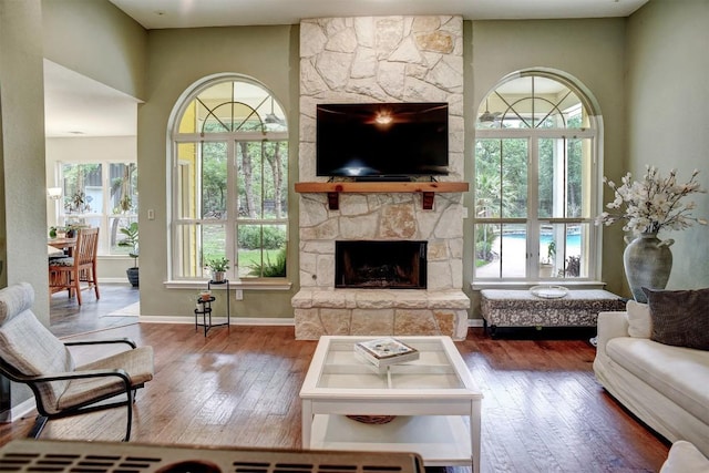 233 Maple Leaf Trl, Elgin, TX 78621 - living area featuring hardwood / wood-style flooring and a stone fireplace