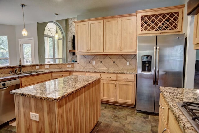 233 Maple Leaf Trl, Elgin, TX 78621 - kitchen featuring stainless steel appliances, a sink, light brown cabinets, tasteful backsplash, and light stone countertops