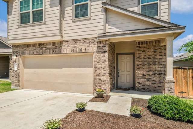 561 Greatest Gift Way, Jarrell, TX 76537 - doorway to property with brick siding, an attached garage, and concrete driveway