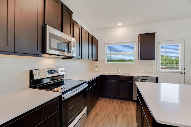 561 Greatest Gift Way, Jarrell, TX 76537 - kitchen featuring stainless steel appliances, a sink, plenty of natural light, light wood-style flooring, and recessed lighting
