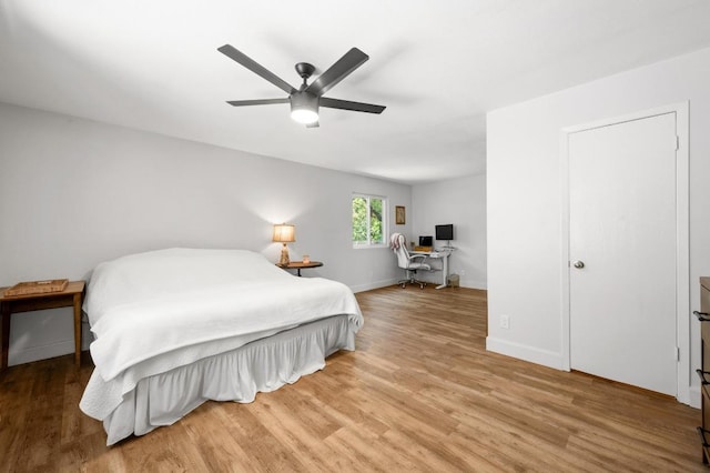 7607 Whispering Winds Dr, Austin, TX 78745 - bedroom with wood finished floors, a desk, baseboards, and a ceiling fan