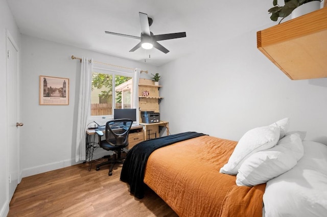 7607 Whispering Winds Dr, Austin, TX 78745 - bedroom with wood finished floors, baseboards, a desk, and a ceiling fan