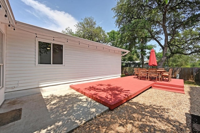 7607 Whispering Winds Dr, Austin, TX 78745 - fenced backyard featuring outdoor dining space, a wooden deck, and a patio