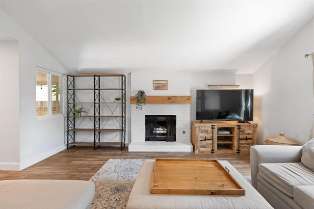 7607 Whispering Winds Dr, Austin, TX 78745 - living room with wood finished floors, a fireplace, baseboards, and vaulted ceiling