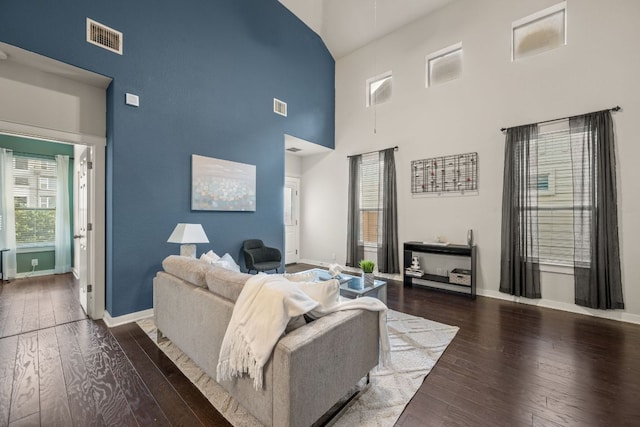 2101 Rivers Edge Way Unit 9, Austin, TX 78741 - living room featuring a towering ceiling, hardwood / wood-style flooring, and baseboards