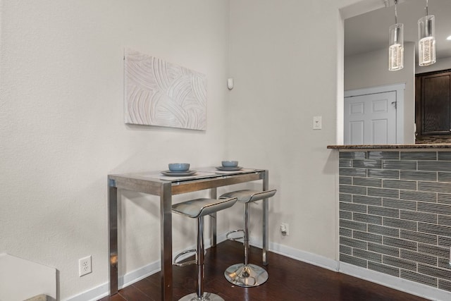 2101 Rivers Edge Way Unit 9, Austin, TX 78741 - dining area featuring baseboards and dark wood finished floors