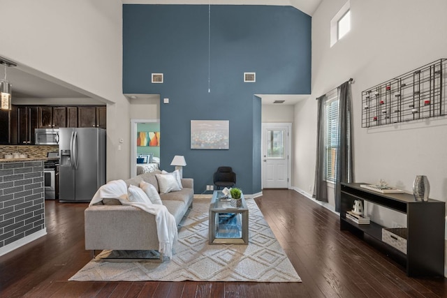 2101 Rivers Edge Way Unit 9, Austin, TX 78741 - living room featuring a high ceiling, plenty of natural light, dark wood-type flooring, and baseboards