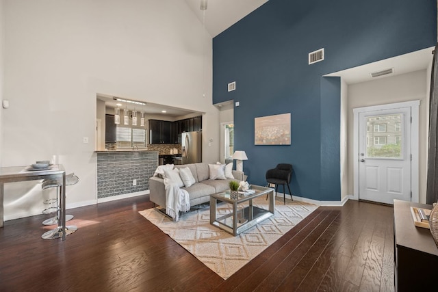 2101 Rivers Edge Way Unit 9, Austin, TX 78741 - living room with high vaulted ceiling, wood-type flooring, and baseboards