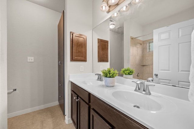 2101 Rivers Edge Way Unit 9, Austin, TX 78741 - bathroom featuring double vanity, baseboards, a shower, and tile patterned flooring