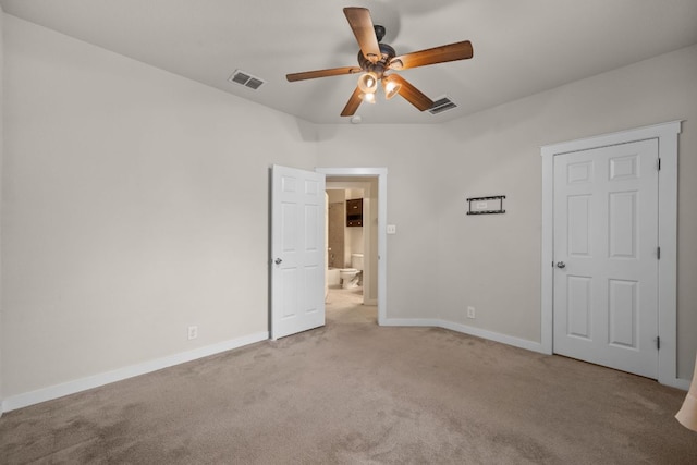 2101 Rivers Edge Way Unit 9, Austin, TX 78741 - unfurnished bedroom featuring light colored carpet, baseboards, and ensuite bathroom