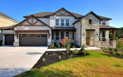 4720 Napoli Shore Dr, Leander, TX 78641 - view of front of property featuring an attached garage, driveway, stone siding, and a front yard
