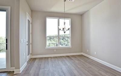 4720 Napoli Shore Dr, Leander, TX 78641 - unfurnished dining area featuring a chandelier, wood finished floors, and baseboards