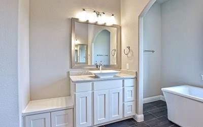 4720 Napoli Shore Dr, Leander, TX 78641 - full bath with a freestanding bath, vanity, and tile patterned floors
