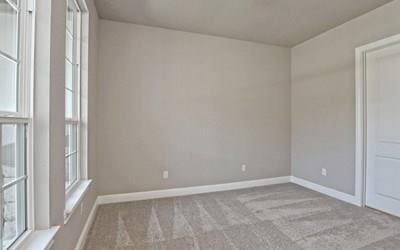 4720 Napoli Shore Dr, Leander, TX 78641 - empty room featuring plenty of natural light, carpet flooring, and baseboards