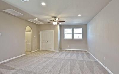 4720 Napoli Shore Dr, Leander, TX 78641 - empty room featuring a ceiling fan, baseboards, recessed lighting, arched walkways, and carpet