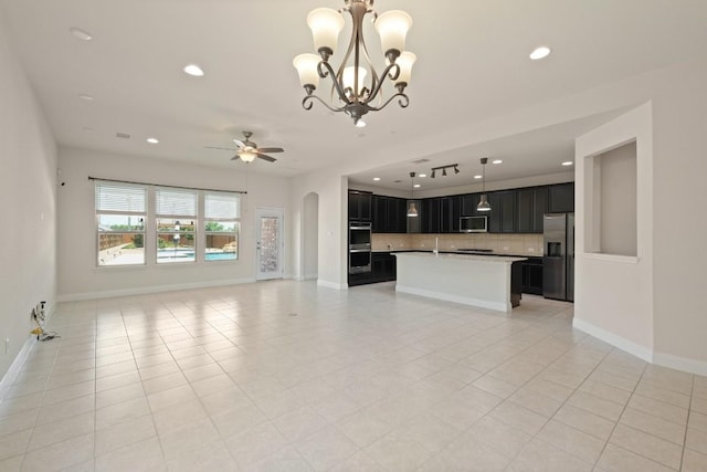 7109 Bargello Pl, Round Rock, TX 78665 - unfurnished living room with ceiling fan, recessed lighting, a chandelier, light tile patterned floors, and baseboards