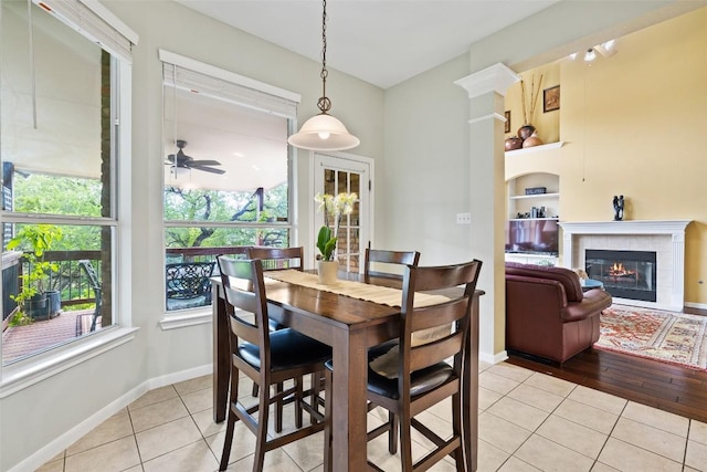 10129 Brimfield Dr, Austin, TX 78726 - dining room with healthy amount of natural light, light tile patterned floors, a ceiling fan, and built in shelves