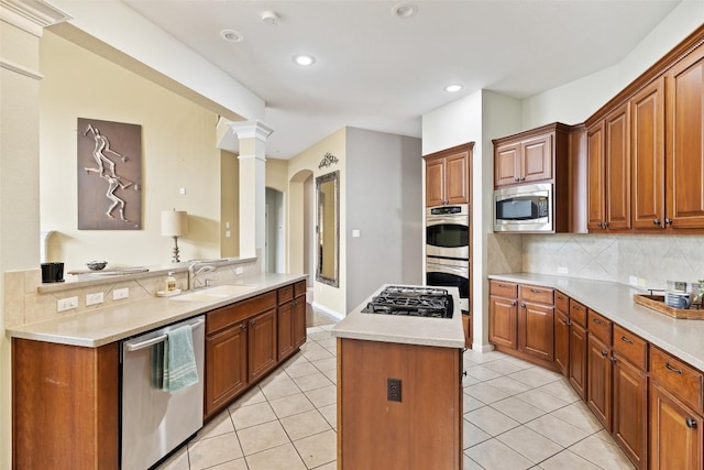 10129 Brimfield Dr, Austin, TX 78726 - kitchen featuring stainless steel appliances, a sink, a kitchen island, light countertops, and recessed lighting