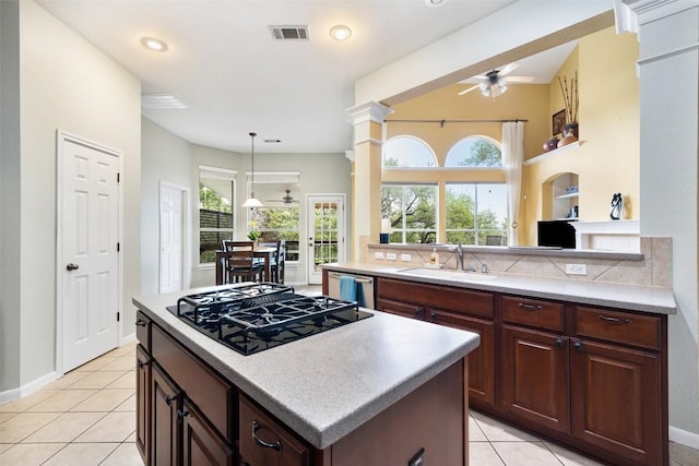 10129 Brimfield Dr, Austin, TX 78726 - kitchen featuring a sink, black gas cooktop, a ceiling fan, stainless steel dishwasher, and light tile patterned floors
